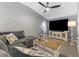 Cozy living room boasts a plush gray sectional sofa and modern decor in a neutrally painted home at 5945 Sunlight Garden Way, Las Vegas, NV 89118