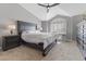 Main bedroom boasts a vaulted ceiling, large bed, and a sitting area with lots of natural light at 5945 Sunlight Garden Way, Las Vegas, NV 89118