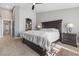 Main bedroom features a large bed and a doorway to the ensuite bathroom with a double sink at 5945 Sunlight Garden Way, Las Vegas, NV 89118