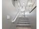 Carpeted stairway featuring a white handrail and gray walls at 5945 Sunlight Garden Way, Las Vegas, NV 89118