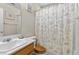 Traditional bathroom features a vanity, a tub with a shower curtain, and white walls at 6611 Cinnabar Coast Ln, North Las Vegas, NV 89084