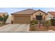Charming single-story home with desert landscaping, a two-car garage, and a neatly tiled roof at 6611 Cinnabar Coast Ln, North Las Vegas, NV 89084