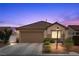 Charming single-story home with desert landscaping, a two-car garage, and a neatly tiled roof at 6611 Cinnabar Coast Ln, North Las Vegas, NV 89084