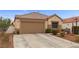 Charming single-story home with desert landscaping, a two-car garage, and a neatly tiled roof at 6611 Cinnabar Coast Ln, North Las Vegas, NV 89084