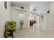 Inviting foyer with tile flooring, decorative vases, and plants, leading to a well-lit living space at 6611 Cinnabar Coast Ln, North Las Vegas, NV 89084