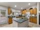 Charming kitchen with large center island, oak cabinets, and backyard access at 6611 Cinnabar Coast Ln, North Las Vegas, NV 89084