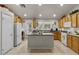 Well-lit kitchen featuring a center island, ample cabinet space, and modern appliances at 6611 Cinnabar Coast Ln, North Las Vegas, NV 89084