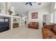 Open living space with tile flooring, comfortable sofas, and a view into the kitchen area at 6611 Cinnabar Coast Ln, North Las Vegas, NV 89084