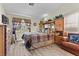 Cozy main bedroom with wood-look floors, an armchair, and dresser at 6611 Cinnabar Coast Ln, North Las Vegas, NV 89084