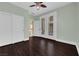 Neutral bedroom featuring wood floors, closet, double doors to patio, and ceiling fan at 7293 Iron Oak Ave, Las Vegas, NV 89113