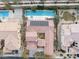 Aerial view showcases a home with a long swimming pool, patio, and solar panels in a well-maintained neighborhood at 7307 Iron Oak Ave, Las Vegas, NV 89113
