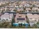 Aerial view showcases the property's pool and spa, solar panels, and its place in a beautiful planned community at 7307 Iron Oak Ave, Las Vegas, NV 89113