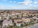 Expansive aerial view of a desert community showcasing diverse homes with desert landscaping and community features at 7307 Iron Oak Ave, Las Vegas, NV 89113