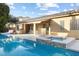 Amazing backyard pool, spa, and covered patio with outdoor dining area at 7307 Iron Oak Ave, Las Vegas, NV 89113