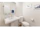 Elegant powder room with pedestal sink, modern fixtures, and stylish wall decor at 7307 Iron Oak Ave, Las Vegas, NV 89113