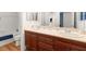 Bathroom featuring double sinks, granite counters, and classic wood cabinetry at 7307 Iron Oak Ave, Las Vegas, NV 89113