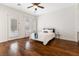 Bright bedroom with wood floors, shutters, and a comfortable queen-sized bed at 7307 Iron Oak Ave, Las Vegas, NV 89113
