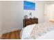 Comfortable bedroom with hardwood floors, a painting on the wall, and simple decor at 7307 Iron Oak Ave, Las Vegas, NV 89113