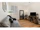 Cozy room featuring hardwood floors, daybed, and shuttered window offering ample natural light at 7307 Iron Oak Ave, Las Vegas, NV 89113