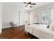 Bedroom featuring wood floors, ample natural light, and a comfortable queen bed at 7307 Iron Oak Ave, Las Vegas, NV 89113