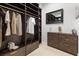 Well-organized walk-in closet featuring a mirror, dark wood shelves and drawers at 7307 Iron Oak Ave, Las Vegas, NV 89113