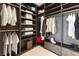 Custom walk-in closet with built-in shelving, drawers and hanging rods for organization at 7307 Iron Oak Ave, Las Vegas, NV 89113