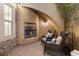 Cozy outdoor fireplace with comfortable seating in a charming courtyard setting at 7307 Iron Oak Ave, Las Vegas, NV 89113