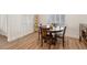 Bright dining area features wood floors, plantation shutters, and a round table for intimate meals at 7307 Iron Oak Ave, Las Vegas, NV 89113