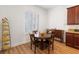 Dining area with plantation shutters, wood floors, and a round wood table near the kitchen at 7307 Iron Oak Ave, Las Vegas, NV 89113
