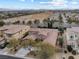 Stunning aerial view showcasing desert landscaping, a backyard pool, and proximity to the community at 7307 Iron Oak Ave, Las Vegas, NV 89113