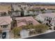 Stunning home aerial view showcasing desert landscaping, a backyard pool, and proximity to the community at 7307 Iron Oak Ave, Las Vegas, NV 89113