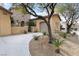 Tan home featuring desert landscaping and a concrete driveway at 7307 Iron Oak Ave, Las Vegas, NV 89113