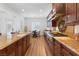 Gourmet kitchen with granite countertops and dark wood cabinetry at 7307 Iron Oak Ave, Las Vegas, NV 89113