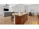 Open-concept kitchen with island seating and a view into the living room at 7307 Iron Oak Ave, Las Vegas, NV 89113