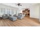 Open concept living room and kitchen area with hardwood floors and comfortable seating at 7307 Iron Oak Ave, Las Vegas, NV 89113