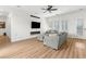 Bright, open living area with a fireplace, TV, and stylish sofas, perfect for relaxation at 7307 Iron Oak Ave, Las Vegas, NV 89113