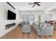 Well-lit living room with fireplace, TV, and multiple sofas for ample seating at 7307 Iron Oak Ave, Las Vegas, NV 89113