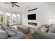 Modern living room with a sleek fireplace, large TV, and comfortable seating for entertaining at 7307 Iron Oak Ave, Las Vegas, NV 89113