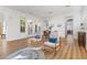 Open-concept living room with wood floors, white walls, and backyard access at 7307 Iron Oak Ave, Las Vegas, NV 89113