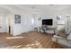 Bright and airy living room with hardwood floors, desk area, and plenty of natural light at 7307 Iron Oak Ave, Las Vegas, NV 89113