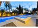 Luxury pool and spa with water features, landscaped yard, and ample seating, ideal for entertaining at 7307 Iron Oak Ave, Las Vegas, NV 89113