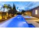 Relaxing pool and spa area with lush landscaping, covered patio, and lounge chairs at twilight at 7307 Iron Oak Ave, Las Vegas, NV 89113