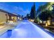 Tranquil pool and spa area with landscaped surroundings and comfortable lounge chairs under the night sky at 7307 Iron Oak Ave, Las Vegas, NV 89113