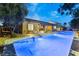 Inviting pool and spa area with covered patio, lounge chairs, and mature landscaping creating a private oasis at 7307 Iron Oak Ave, Las Vegas, NV 89113