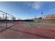 Outdoor tennis courts with nets and fencing, surrounded by trees, under a sunny sky at 7307 Iron Oak Ave, Las Vegas, NV 89113