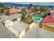 Aerial view of a home with a pool, large parking area and lush landscaping at 8880 W La Mancha Ave, Las Vegas, NV 89149