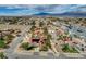 An aerial view displays the well-maintained house featuring a private pool and lush backyard at 8880 W La Mancha Ave, Las Vegas, NV 89149