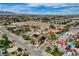 A desert home shows solar panel roof, spacious driveway, and desert landscaping from this aerial shot at 8880 W La Mancha Ave, Las Vegas, NV 89149