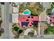 Aerial shot of a home featuring solar panels, circular drive, and desert landscaping at 8880 W La Mancha Ave, Las Vegas, NV 89149