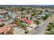 An aerial view shows the spacious home with pool, solar panels, complemented by lush landscaping and ample parking at 8880 W La Mancha Ave, Las Vegas, NV 89149